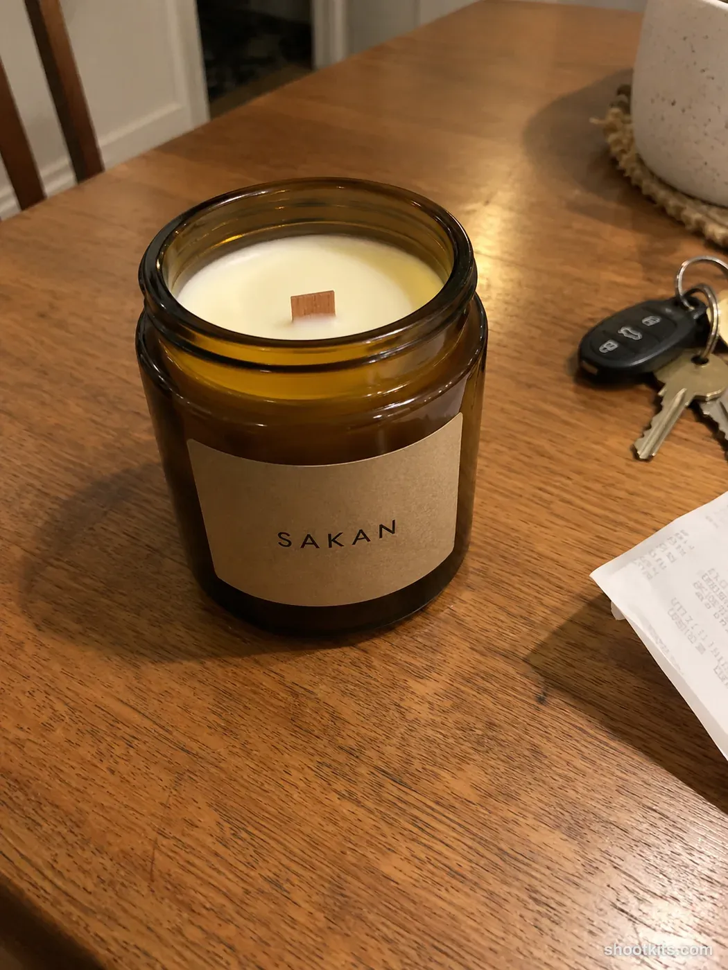 Before: a casual phone photo of a jar candle