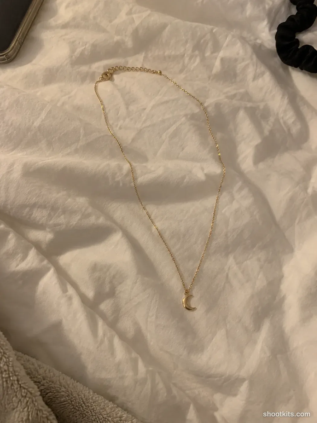Before: a casual phone photo of a gold necklace